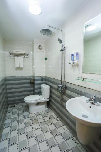 a bathroom with a toilet and a sink at Hotel Sunny HG in Ha Long