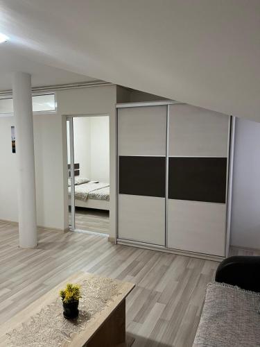 a living room with a large sliding glass door at Apartmani Vrla in Vladičin Han