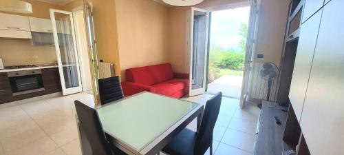 a living room with a red couch and a table at Antico Principato di Seborga in Vallebona