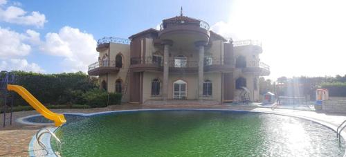 a large house with a pool in front of it at Villa king mariot in Alexandria