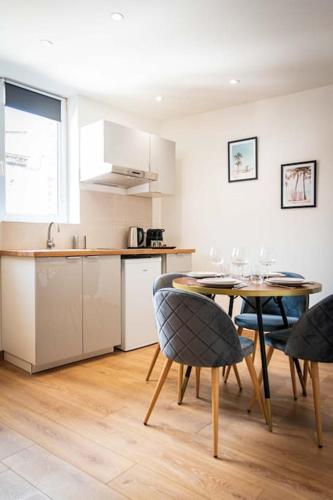une cuisine et une salle à manger avec une table et des chaises dans l'établissement L'Albatros 009 - Hypercentre * Cosy * Wifi, à Saint-Quentin