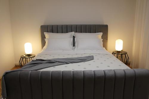 a large bed with two lamps on both sides of it at MARIAS in Senj