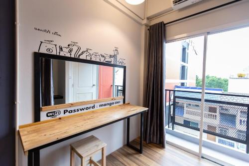 a dressing room with a mirror and a balcony at Mango 10 House in Bangkok
