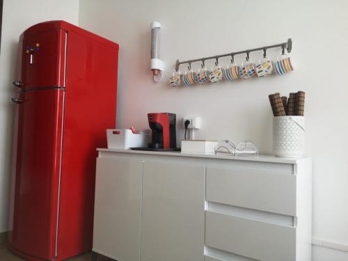 a red refrigerator in a kitchen with a counter at Tulla's in Giardini Naxos