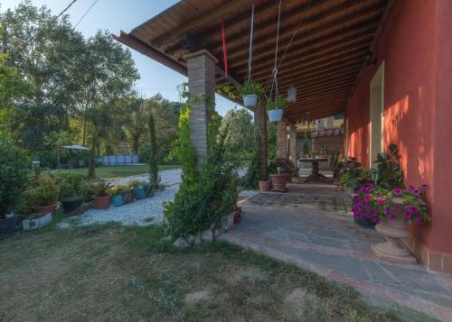 a porch with potted plants on the side of a building at La Casa Rossa in Coiano