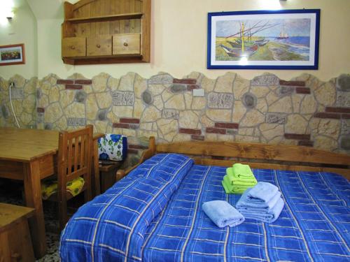Una cama o camas en una habitación de Diving Center Punta Stilo