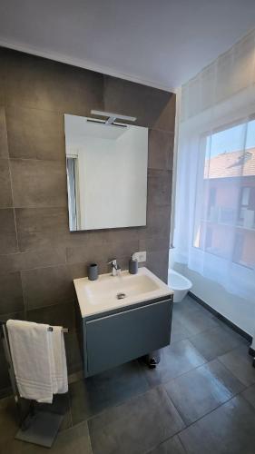 a bathroom with a sink and a mirror and a toilet at Comfort Accommodation Room in Bergamo