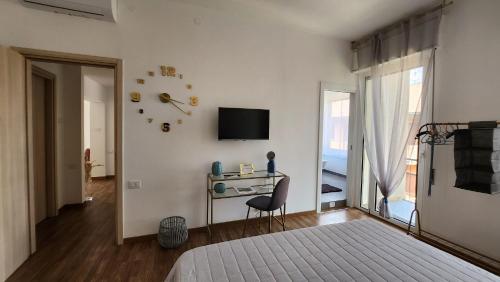 a bedroom with a bed and a desk and a television at Comfort Accommodation Room in Bergamo