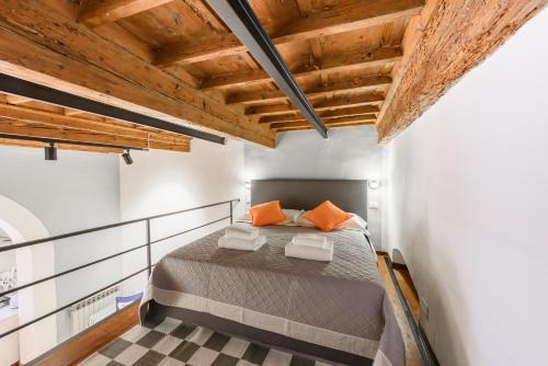 a bedroom with a bed and a wooden ceiling at Classic Loft by Mmega in Florence