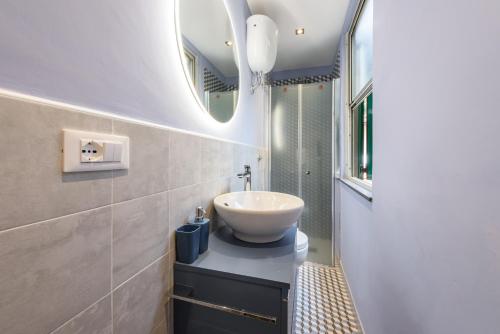 a bathroom with a sink and a mirror at Classic Loft by Mmega in Florence