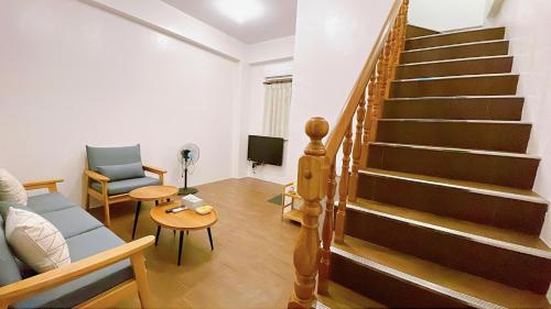 a living room with a staircase and a couch at Sun B&B in Taitung City