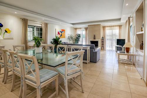 a living room with a glass table and chairs at Villa Mar Ali - JACUZZI - 400m from the beach - BY BEDZY in Albufeira