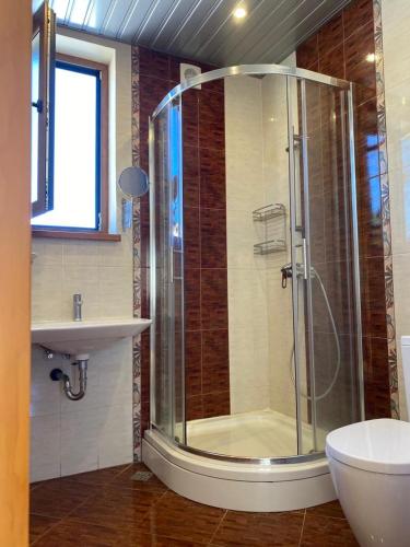 a bathroom with a shower and a sink at Villa Eseniya in Tivat