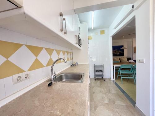 a kitchen with a sink in a room at Blue Apartment in Benidorm