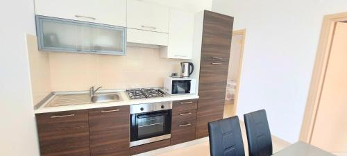 a kitchen with a sink and a stove top oven at Antico Principato di Seborga in Vallebona