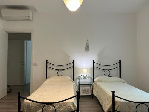 A bed or beds in a room at Appartamento in villetta a 2 passi dal mare e dal centro