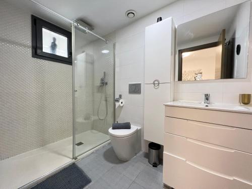 a bathroom with a shower and a toilet and a sink at Ocean View Apartment in Arenales del Sol