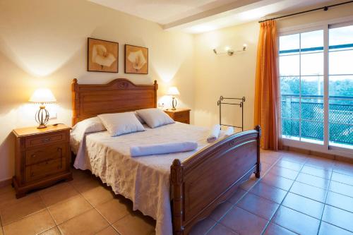 a bedroom with a large bed and a large window at Ca na Catalina in Sant Jordi