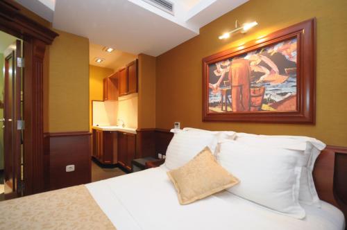 a hotel room with a bed and a painting on the wall at Luxury Sea Residence by Kristina in Tivat