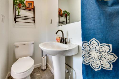 a bathroom with a white toilet and a sink at Jonesboro Retreat Near Arkansas State University! in Jonesboro