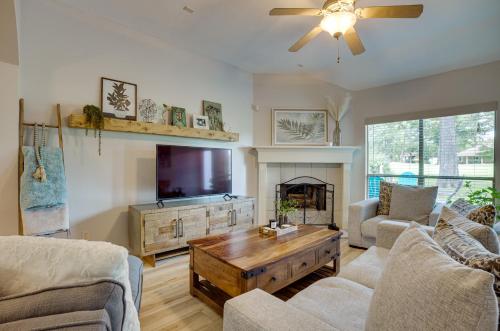 a living room with a tv and a couch and a table at Community Pool Access Montgomery Retreat! in Montgomery