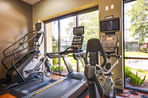 a gym with two treadmill machines and a large window at Community Pool Access Montgomery Retreat! in Montgomery