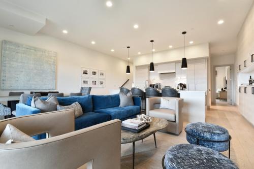 a living room with a blue couch and a table at JL802 Juniper Landing Jewel in Park City
