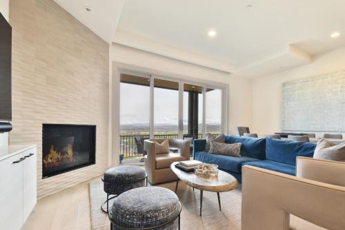 a living room with a blue couch and a fireplace at JL802 Juniper Landing Jewel in Park City