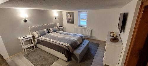 a small bedroom with a bed and a television at Malcherhaus 