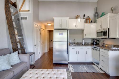 a kitchen with white cabinets and a stainless steel refrigerator at Condo with Community Pool and Boat Ramp in Osage Beach in Osage Beach