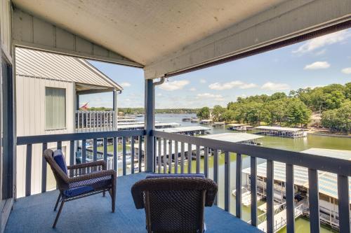 a balcony with two chairs and a view of a river at Condo with Community Pool and Boat Ramp in Osage Beach in Osage Beach