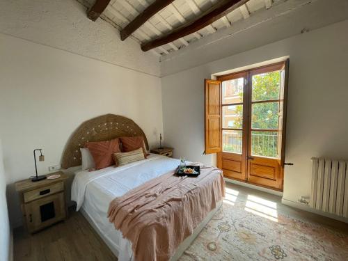ein Schlafzimmer mit einem großen Bett und einem großen Fenster in der Unterkunft Villa Elena Can Quintana in Pineda de Mar