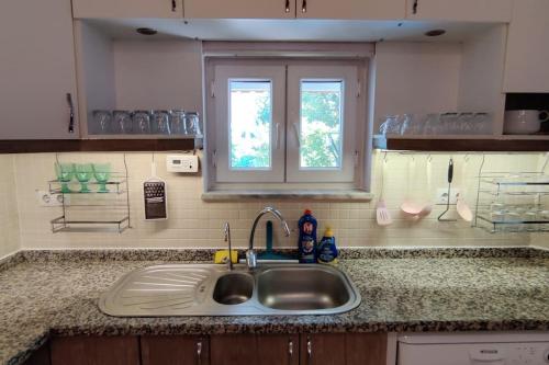 a kitchen counter with a sink and a window at Arslan Villa with Pool in Marmaris