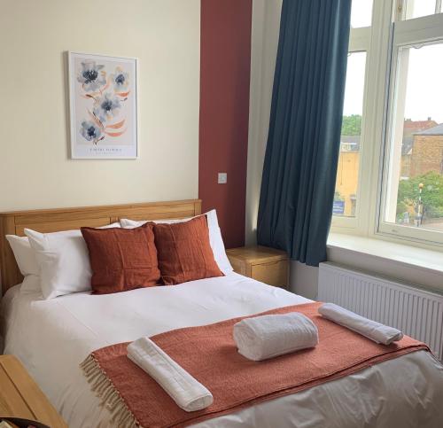 a bedroom with a bed with two towels on it at The Fox & Hounds in Forest Hill