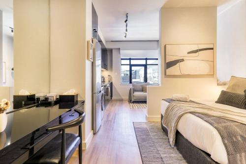 a bedroom with a bed and a living room at Luxury Mountain View Aparthotel at The Tokyo- 12th Floor No Loadshedding in Cape Town