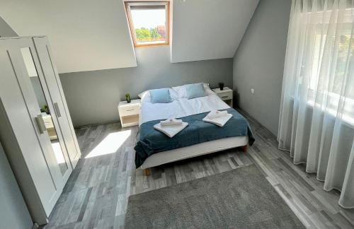 a bedroom with a bed with two towels on it at Pacek Keco in Alsóörs
