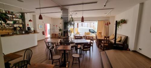 a restaurant with tables and chairs in a room at Aldeia de Portimão in Portimão