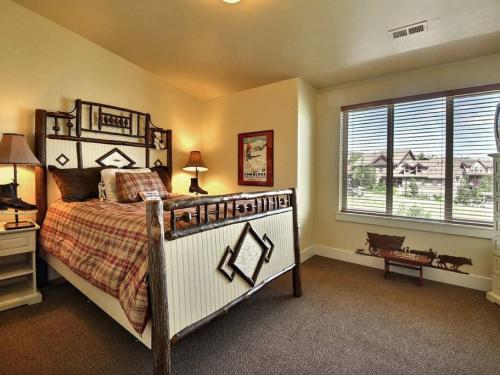 a bedroom with a large bed and a window at BH5555 Slalom Lodge in Park City