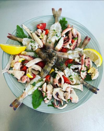 a plate of food with shrimp and vegetables on a table at Restorant Hotel Xheni in Durrës