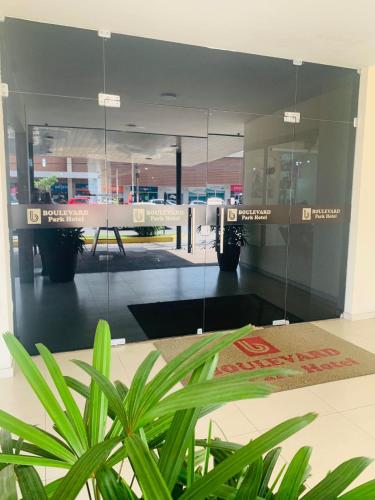 a glass wall in a room with a potted plant at Boulevard Park Hotel in São Luís