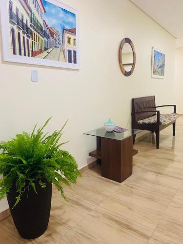 a room with a table and a potted plant at Boulevard Park Hotel in São Luís