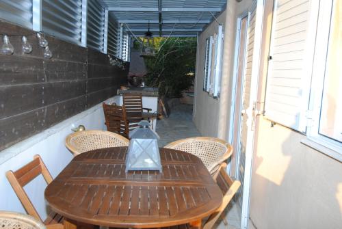 a wooden table and chairs on a patio at Villa Sofia in Marmari