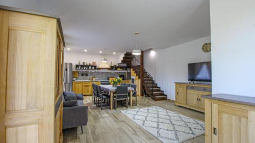 a kitchen and living room with a table and a dining room at RunCa-n Rai in Cristian