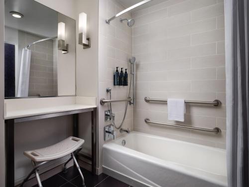 a bathroom with a tub and a sink and a toilet at Aloft El Segundo - Los Angeles Airport in El Segundo