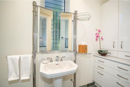a white bathroom with a sink and a mirror at Kapalua Villas Maui - Select Your Unit in Kahana