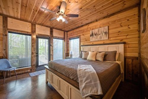 a bedroom with a bed and a ceiling fan at Over The Edge in Broken Bow