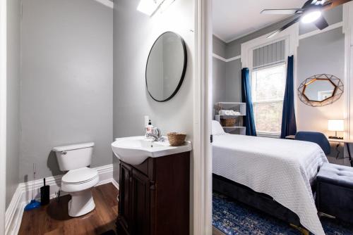 a bathroom with a bed and a sink and a mirror at Suite near downtown Louisville, KY - Suite II in Louisville