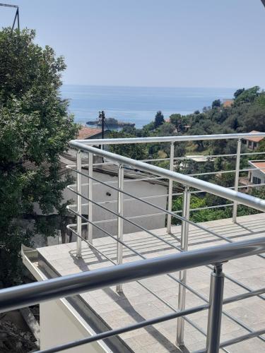 a metal railing on a balcony with a view of the ocean at Nino Lux Apartments Ulcinj in Ulcinj