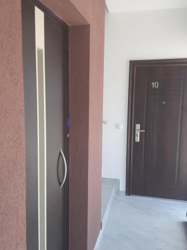 a hallway with a door with a number on it at Nino Lux Apartments Ulcinj in Ulcinj