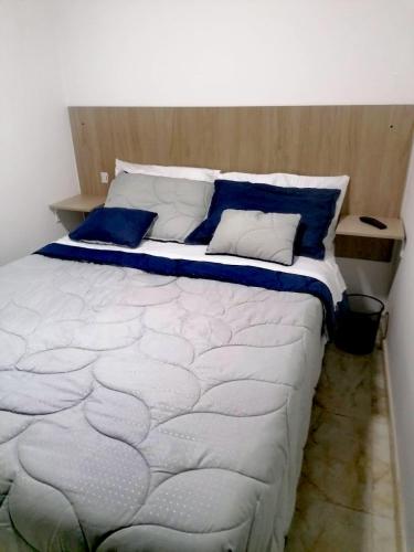 a bedroom with a large bed with blue pillows at Hospedaje 51b in Bogotá
